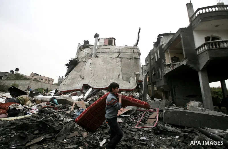 A Palestinian children in the rubble of a destroyed building following an Israeli air strike in the east of Jabaliya refugee camp on, 12 March 2012. Reports state that an Israeli air strike on the northern Gaza Strip's J...