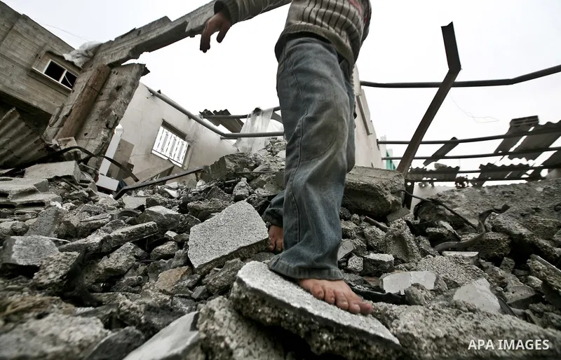 A Palestinian children in the rubble of a destroyed building following an Israeli air strike in the east of Jabaliya refugee camp on, 12 March 2012. Reports state that an Israeli air strike on the northern Gaza Strip's J...