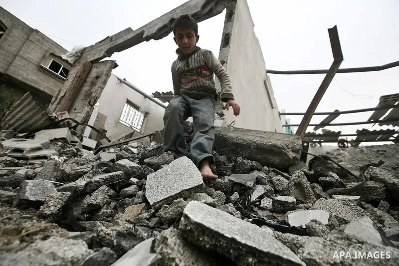 A Palestinian children in the rubble of a destroyed building following an Israeli air strike in the east of Jabaliya refugee camp on, 12 March 2012. Reports state that an Israeli air strike on the northern Gaza Strip's J...