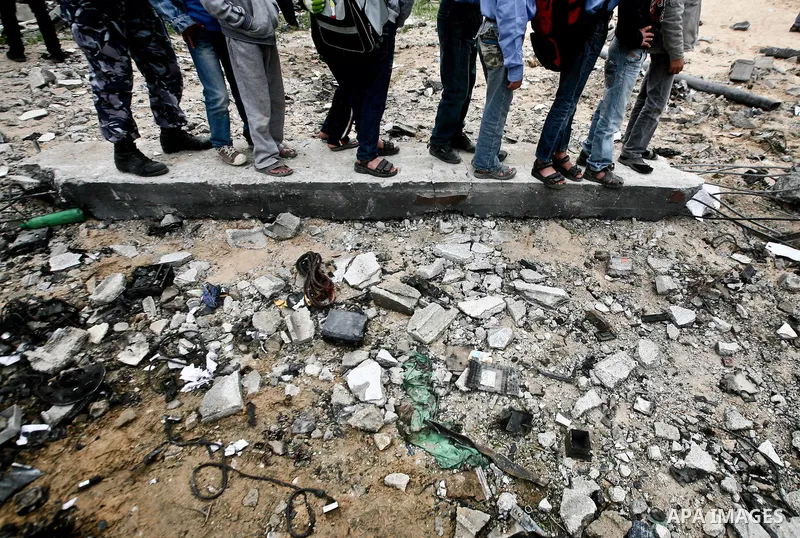 Palestinians amongst the rubble of a destroyed building of senior Islamic Jihad militant following an Israeli air strike in the east of Jabaliya refugee camp on, 12 March 2012. Reports state that an Israeli air strike on...
