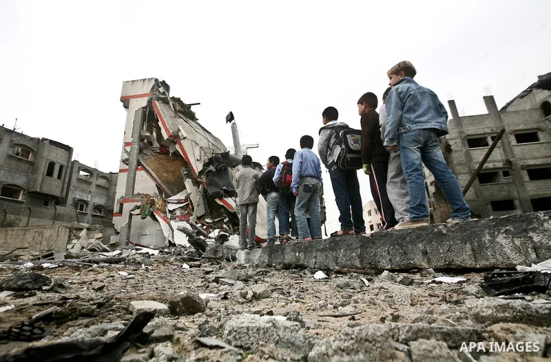 A Palestinian children in the rubble of a destroyed building following an Israeli air strike in the east of Jabaliya refugee camp on, 12 March 2012. Reports state that an Israeli air strike on the northern Gaza Strip's J...