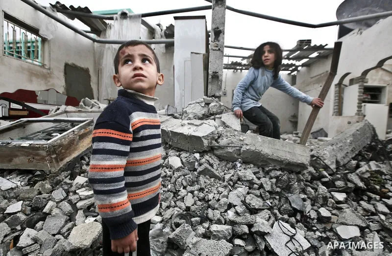 A Palestinian children in the rubble of a destroyed building following an Israeli air strike in the east of Jabaliya refugee camp on, 12 March 2012. Reports state that an Israeli air strike on the northern Gaza Strip's J...