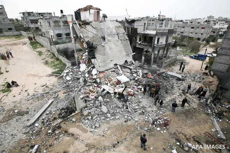Palestinians amongst the rubble of a destroyed building of senior Islamic Jihad militant following an Israeli air strike in the east of Jabaliya refugee camp on, 12 March 2012. Reports state that an Israeli air strike on...