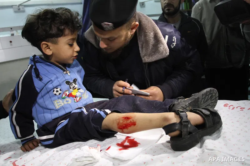A wounded Palestinian boy is wheeled into a hospital in Gaza City, after an Israeli air strike March 12, 2012. Israeli air strikes killed two Palestinian militants and a civilian in the Gaza Strip on Monday in a fourth d...