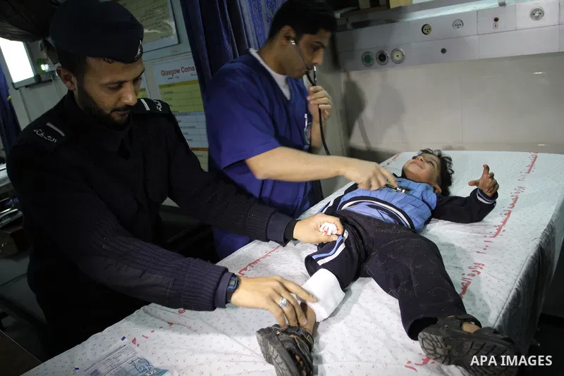A wounded Palestinian boy is wheeled into a hospital in Gaza City, after an Israeli air strike March 12, 2012. Israeli air strikes killed two Palestinian militants and a civilian in the Gaza Strip on Monday in a fourth d...