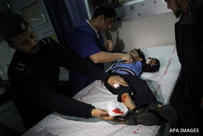 A wounded Palestinian boy is wheeled into a hospital in Gaza City, after an Israeli air strike March 12, 2012. Israeli air strikes killed two Palestinian militants and a civilian in the Gaza Strip on Monday in a fourth d...