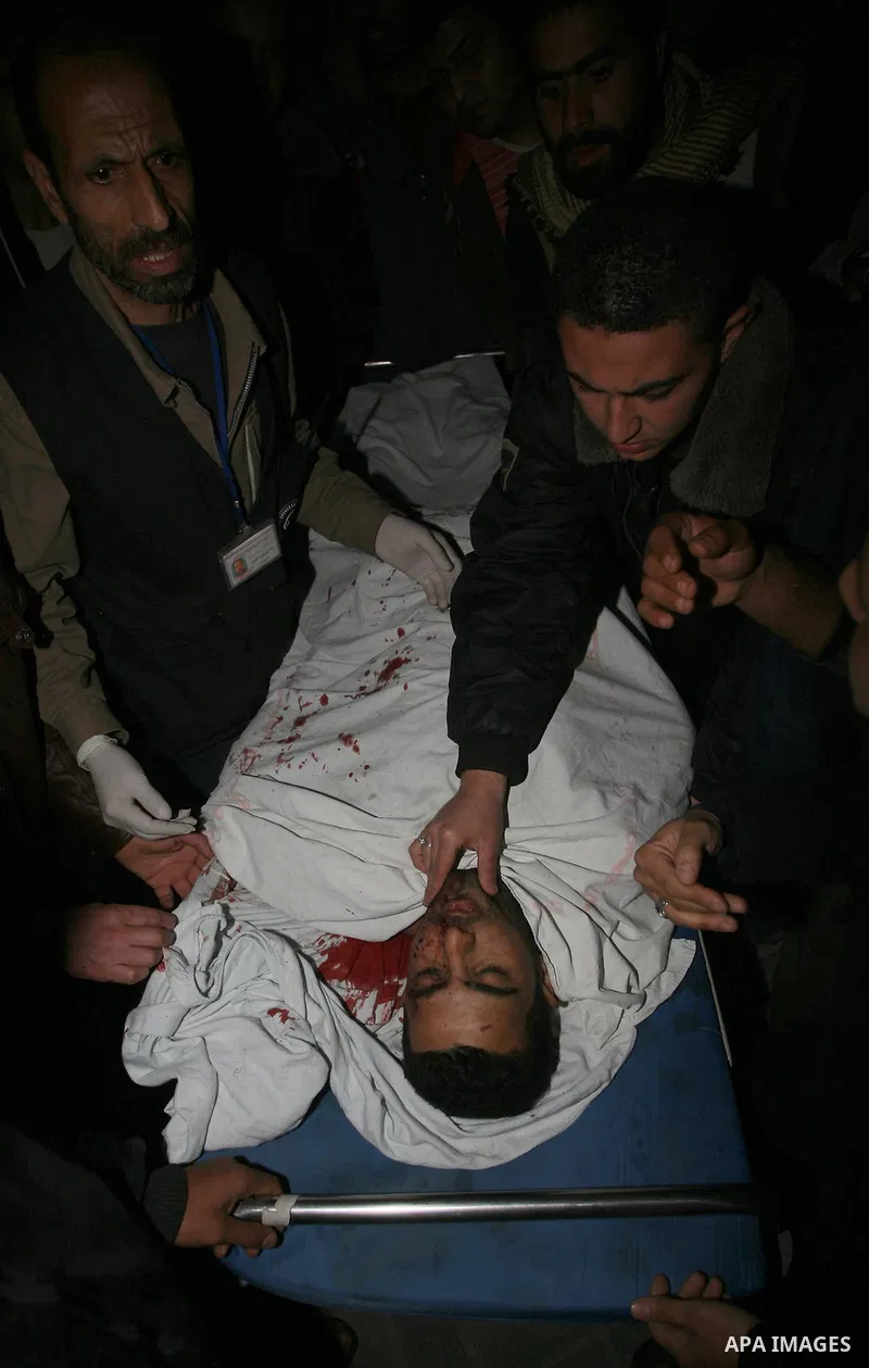 One of two Islamic Jihad militants who were killed in an Israeli airstrike on March 12, 2012 is transported into the morgue of Al-Shifa Hospital in Gaza city, as Israeli warplanes pounded Gaza for a fourth day, killing s...
