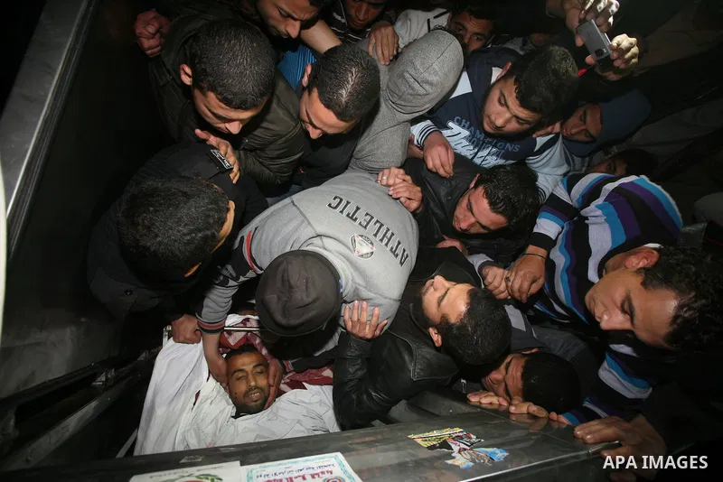 One of two Islamic Jihad militants who were killed in an Israeli airstrike on March 12, 2012 is transported into the morgue of Al-Shifa Hospital in Gaza city, as Israeli warplanes pounded Gaza for a fourth day, killing s...