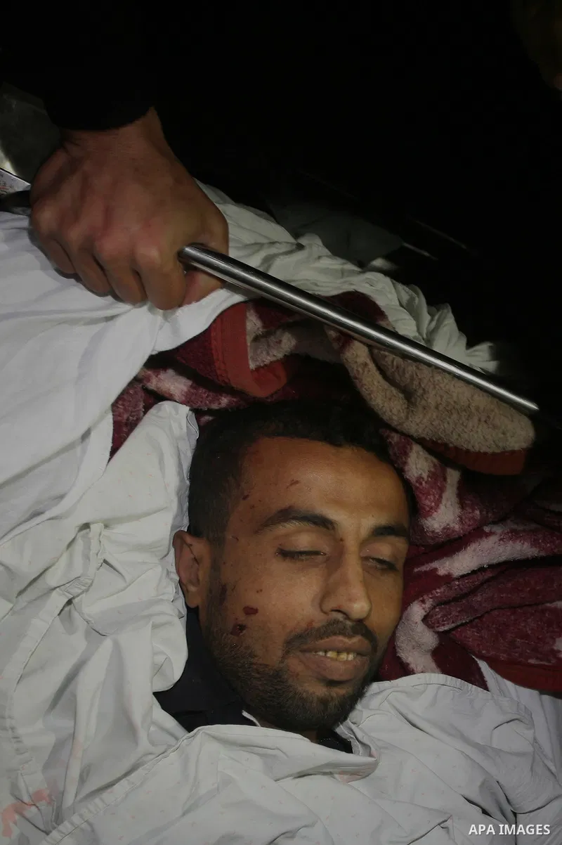 One of two Islamic Jihad militants who were killed in an Israeli airstrike on March 12, 2012 is transported into the morgue of Al-Shifa Hospital in Gaza city, as Israeli warplanes pounded Gaza for a fourth day, killing s...