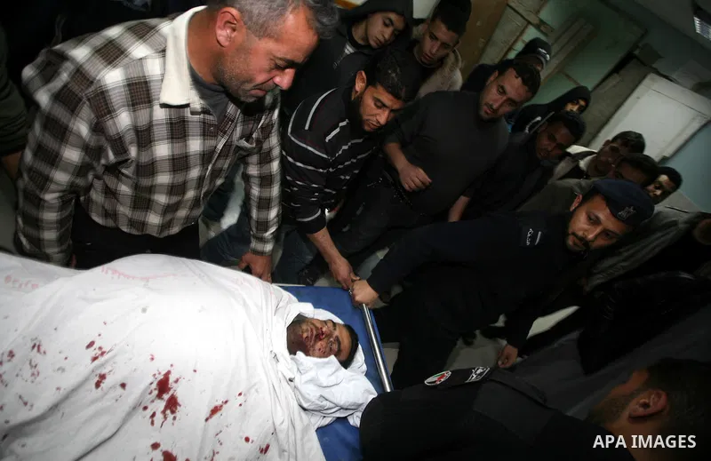 One of two Islamic Jihad militants who were killed in an Israeli airstrike on March 12, 2012 is transported into the morgue of Al-Shifa Hospital in Gaza city, as Israeli warplanes pounded Gaza for a fourth day, killing s...