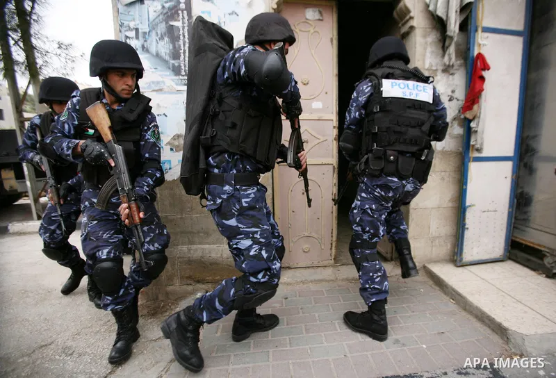 Members of the Palestinian security forces make a mock arrest during a training drill in the West Bank city of Hebron March 12, 2012. Photo by Mamoun Wazwaz