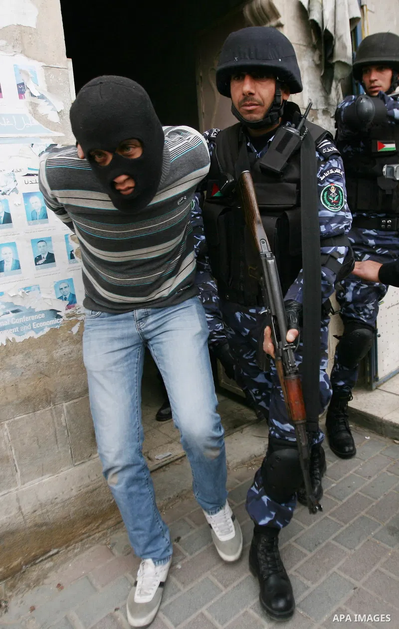 Members of the Palestinian security forces make a mock arrest during a training drill in the West Bank city of Hebron March 12, 2012. Photo by Mamoun Wazwaz