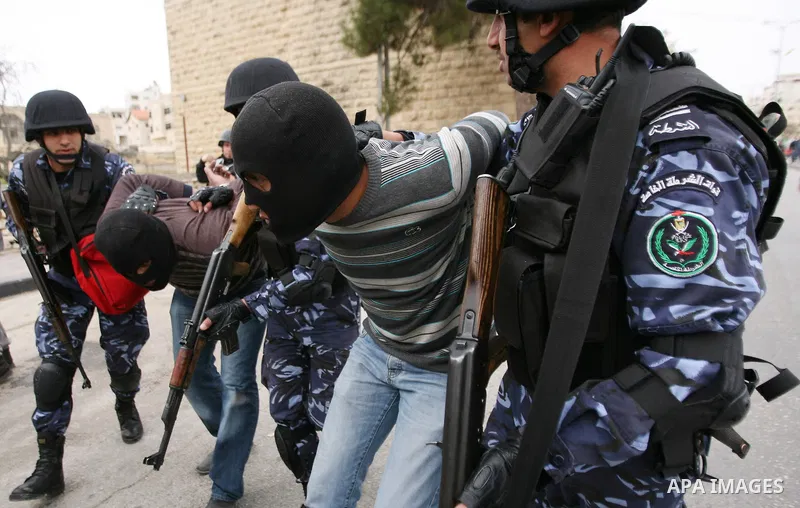 Members of the Palestinian security forces make a mock arrest during a training drill in the West Bank city of Hebron March 12, 2012. Photo by Mamoun Wazwaz