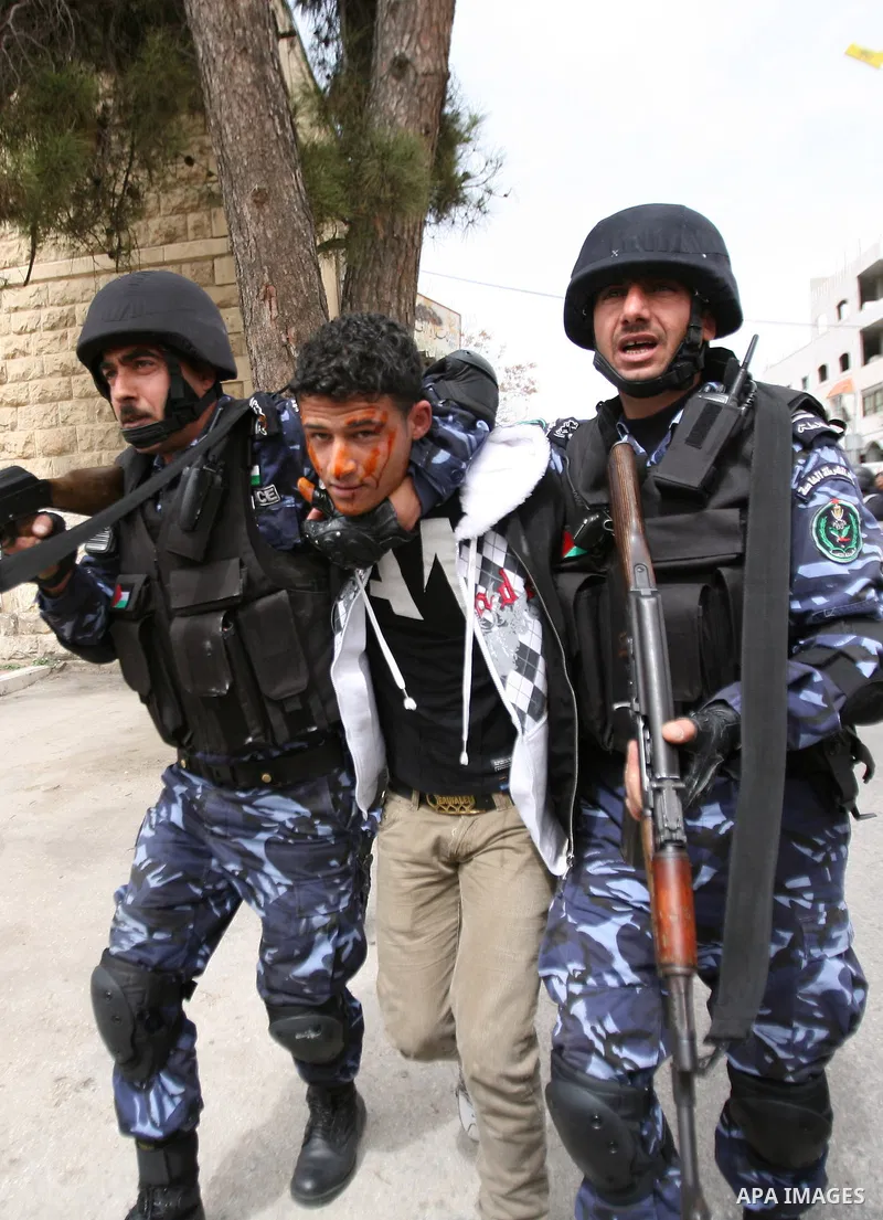 Members of the Palestinian security forces make a mock arrest during a training drill in the West Bank city of Hebron March 12, 2012. Photo by Mamoun Wazwaz
