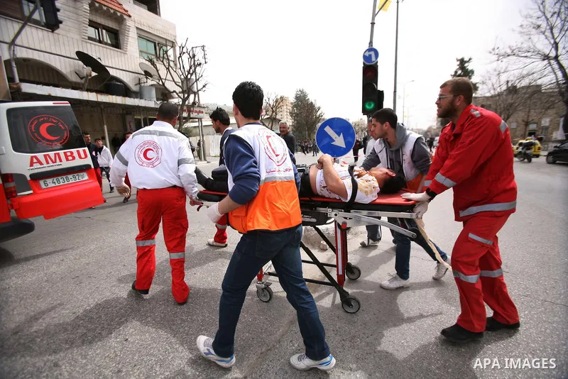 Palestinian medics tend to a member of the Palestinian security forces playing the role of a mock victim as they take part in a training drill in the West Bank city of Hebron March 12, 2012. Photo by Mamoun Wazwaz