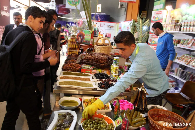 Palestinians attend exhibition for Palestinian food in Gaza City on Mar. 13, 2012. to support the Palestinian national products. Photo by Mohammed Asad