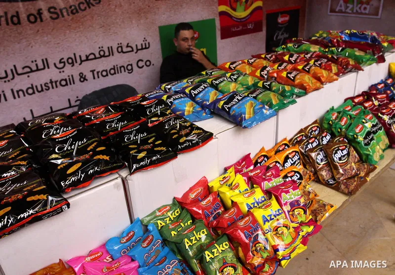 Palestinians attend exhibition for Palestinian food in Gaza City on Mar. 13, 2012. to support the Palestinian national products. Photo by Mohammed Asad