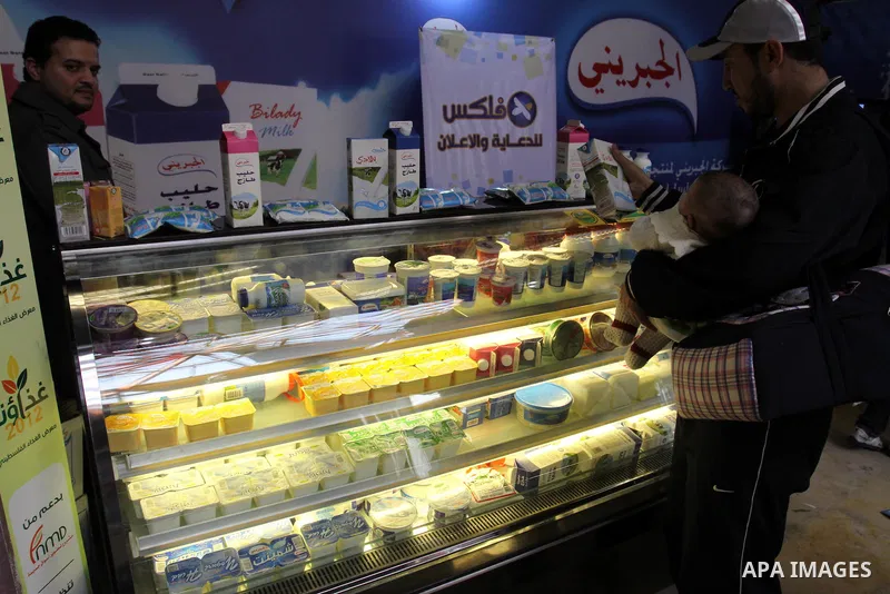 Palestinians attend exhibition for Palestinian food in Gaza City on Mar. 13, 2012. to support the Palestinian national products. Photo by Mohammed Asad