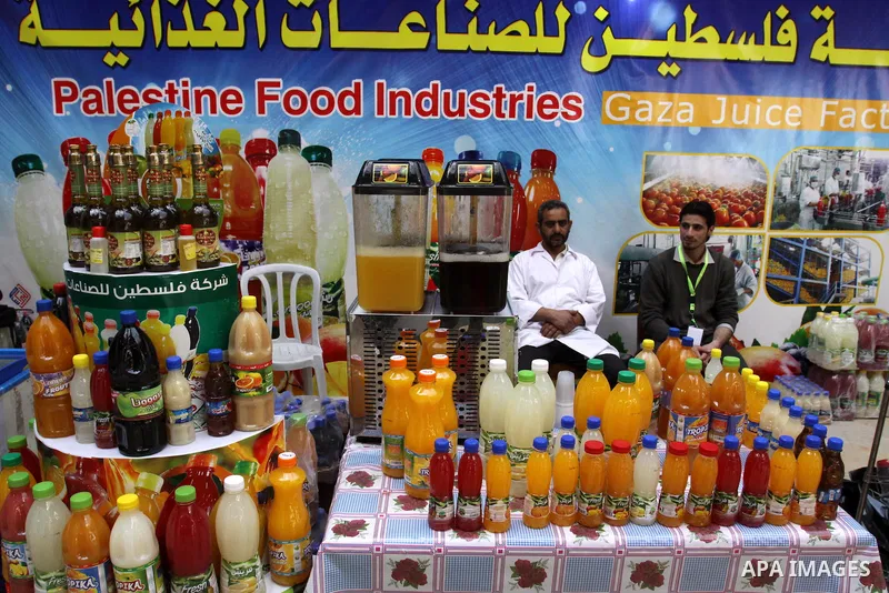 Palestinians attend exhibition for Palestinian food in Gaza City on Mar. 13, 2012. to support the Palestinian national products. Photo by Mohammed Asad