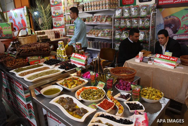 Palestinians attend exhibition for Palestinian food in Gaza City on Mar. 13, 2012. to support the Palestinian national products. Photo by Mohammed Asad