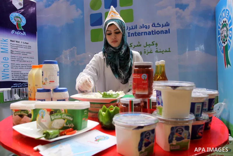 Palestinians attend exhibition for Palestinian food in Gaza City on Mar. 13, 2012. to support the Palestinian national products. Photo by Mohammed Asad