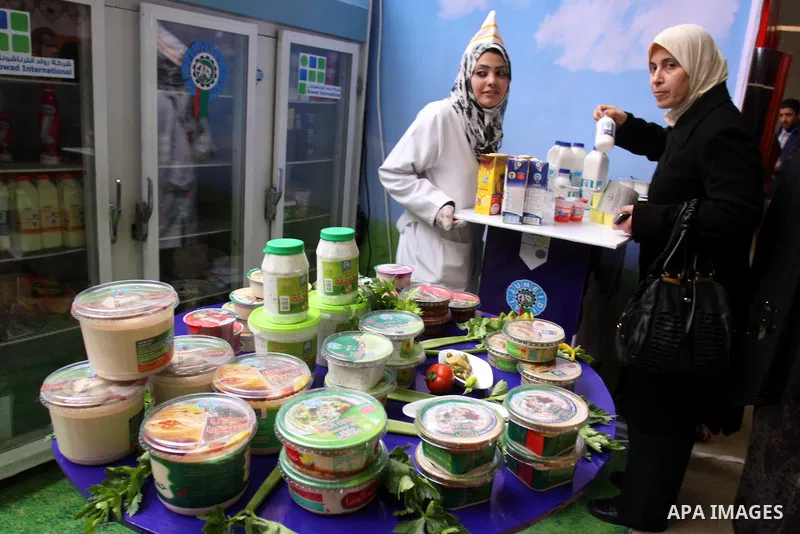 Palestinians attend exhibition for Palestinian food in Gaza City on Mar. 13, 2012. to support the Palestinian national products. Photo by Mohammed Asad