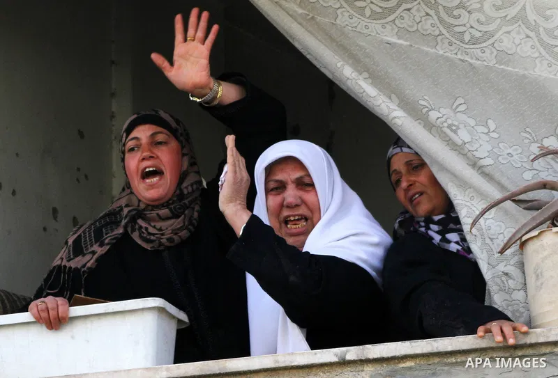 Palestinian relatives of Islamic Jihad militant Bassam El-Ejla, who was killed the night before along with another comrade in an Israeli air strike, mourn during his funeral in Gaza City on March 13, 2012. Israel and mil...