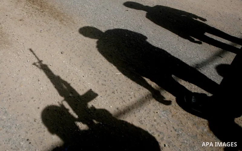A Palestinian fires a weapon in the air during the funeral of Islamic Jihad militant Mohammed Daher in Gaza City March 13, 2012. An Egyptian-brokered truce between Israel and militant groups in the Gaza Strip began to ta...