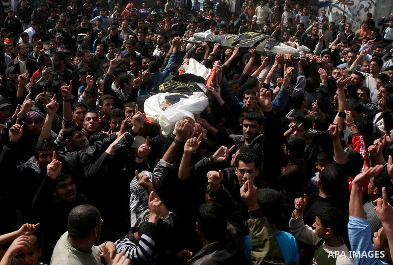 Palestinian mourners carry the bodies of two Islamic Jihad militants killed in Israeli strikes on Gaza Tuesday, during their funeral in Gaza City, Tuesday, March 13, 2012 . Israel halted its airstrikes against Gaza Strip...