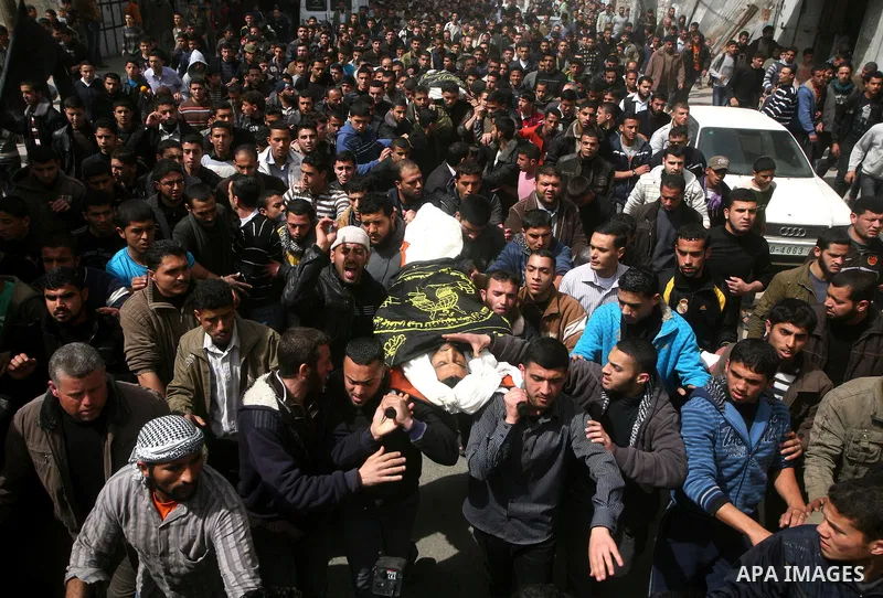 Palestinian mourners carry the bodies of two Islamic Jihad militants killed in Israeli strikes on Gaza Tuesday, during their funeral in Gaza City, Tuesday, March 13, 2012 . Israel halted its airstrikes against Gaza Strip...