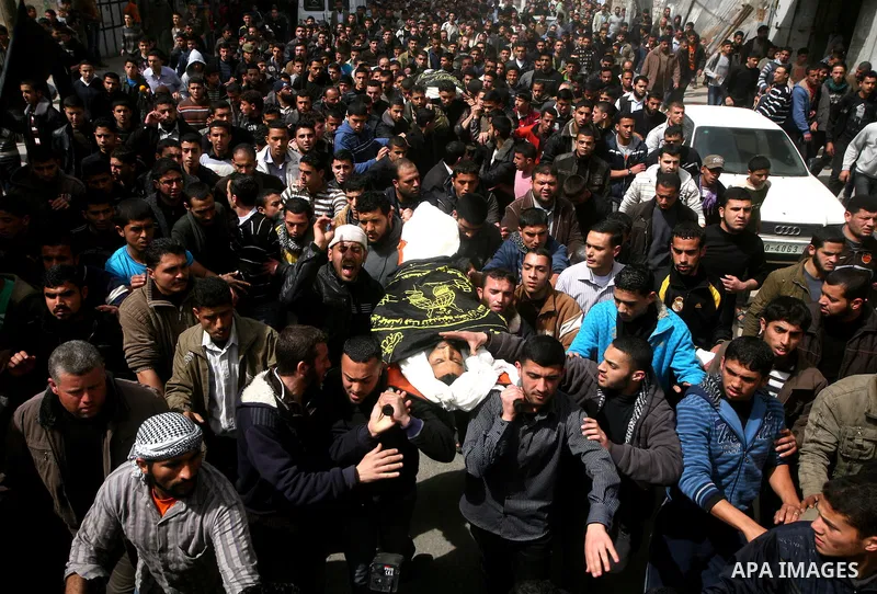 Palestinian mourners carry the bodies of two Islamic Jihad militants killed in Israeli strikes on Gaza Tuesday, during their funeral in Gaza City, Tuesday, March 13, 2012 . Israel halted its airstrikes against Gaza Strip...