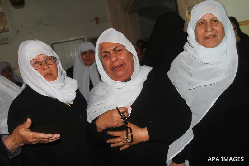 Palestinian relatives of Islamic Jihad militant Bassam El-Ejla, who was killed the night before along with another comrade in an Israeli air strike, mourn during his funeral in Gaza City on March 13, 2012. Israel and mil...