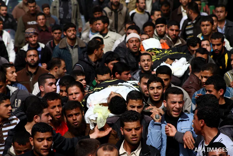 Palestinian mourners carry the bodies of two Islamic Jihad militants killed in Israeli strikes on Gaza Tuesday, during their funeral in Gaza City, Tuesday, March 13, 2012 . Israel halted its airstrikes against Gaza Strip...
