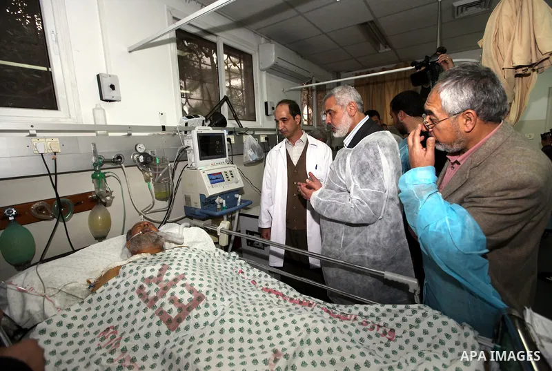 Palestinian Prime Minister in Gaza Strip, Ismail Haniyeh, visits a number of palestinians wounded of the Shifa hospital in Gaza City, on Mar. 13, 2012. Photo by Ahmed Shaat