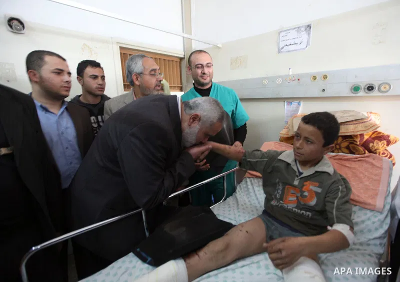 Palestinian Prime Minister in Gaza Strip, Ismail Haniyeh, visits a number of palestinians wounded of the Shifa hospital in Gaza City, on Mar. 13, 2012. Photo by Ahmed Shaat