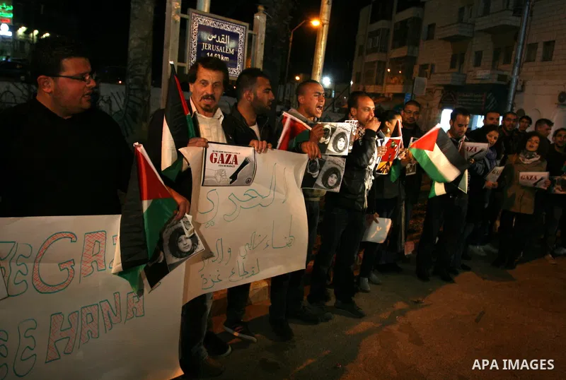 Palestinians take part in a protest in the center of the West Bank city of Ramallah on Mar. 13, 2012, to show their support for the Gaza Strip and against Israeli air strikes. Israel will continue air strikes against Gaz...