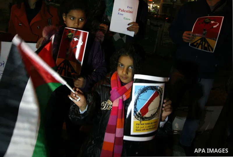 Palestinians take part in a protest in the center of the West Bank city of Ramallah on Mar. 13, 2012, to show their support for the Gaza Strip and against Israeli air strikes. Israel will continue air strikes against Gaz...