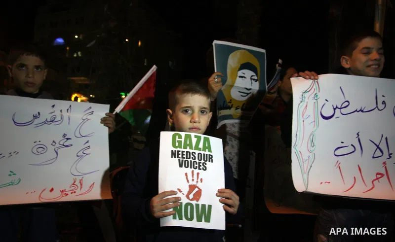Palestinians take part in a protest in the center of the West Bank city of Ramallah on Mar. 13, 2012, to show their support for the Gaza Strip and against Israeli air strikes. Israel will continue air strikes against Gaz...