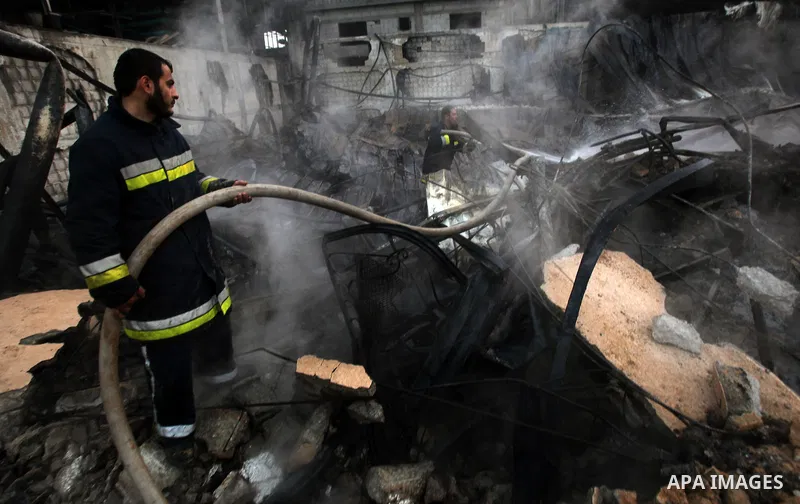 Palestinian firemen extinguish a fire at a building on March 14, 2012, after an Israeli air strike on Gaza City. Israel and militants in Gaza began observing an Egyptian-brokered truce on March 13, after four days of vio...
