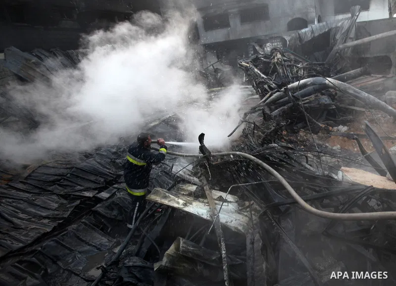 Palestinian firemen extinguish a fire at a building on March 14, 2012, after an Israeli air strike on Gaza City. Israel and militants in Gaza began observing an Egyptian-brokered truce on March 13, after four days of vio...