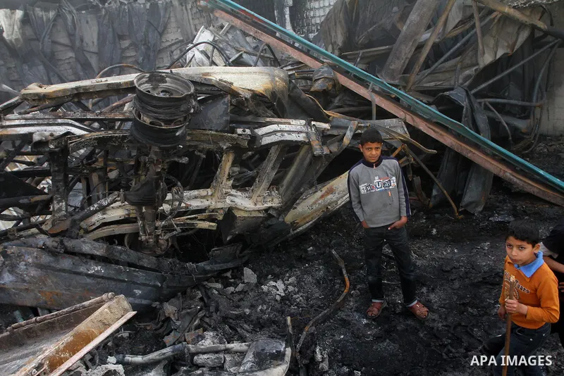 Palestinians inspect destroyed buildings on March 14, 2012, following an Israeli air strike on Gaza City. Israel and militants in Gaza began observing an Egyptian-brokered truce on March 13, after four days of violence,...