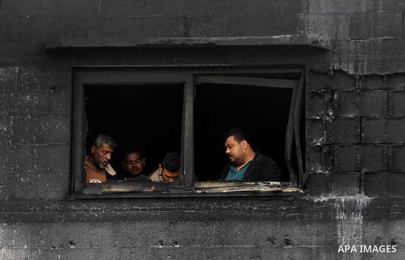 Palestinians inspect destroyed buildings on March 14, 2012, following an Israeli air strike on Gaza City. Israel and militants in Gaza began observing an Egyptian-brokered truce on March 13, after four days of violence,...