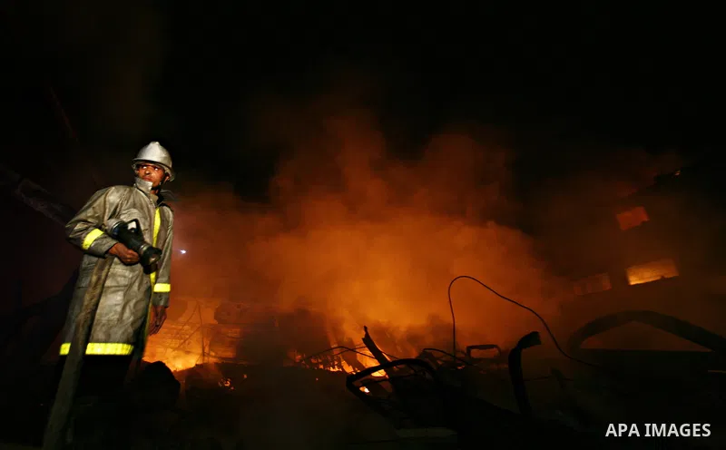 Palestinian fire fighters try to extinguish a blaze at a burning factory after an Israeli missile strike in the east of Gaza Strip on 14 March 2012. A fragile truce appeared to be taking hold between Israel and Palestini...