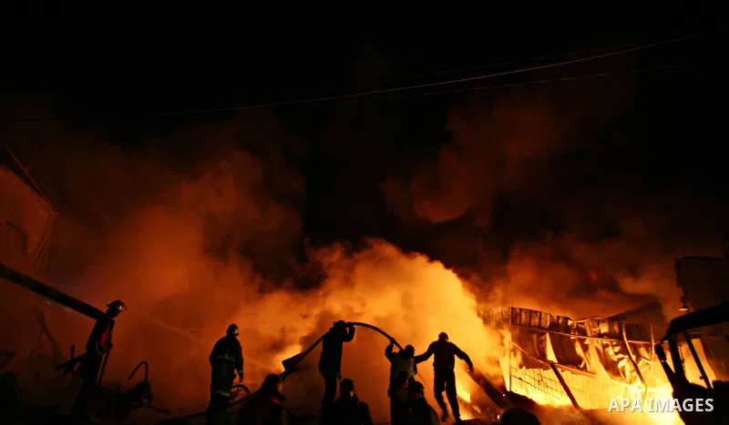 Palestinian fire fighters try to extinguish a blaze at a burning factory after an Israeli missile strike in the east of Gaza Strip on 14 March 2012. A fragile truce appeared to be taking hold between Israel and Palestini...