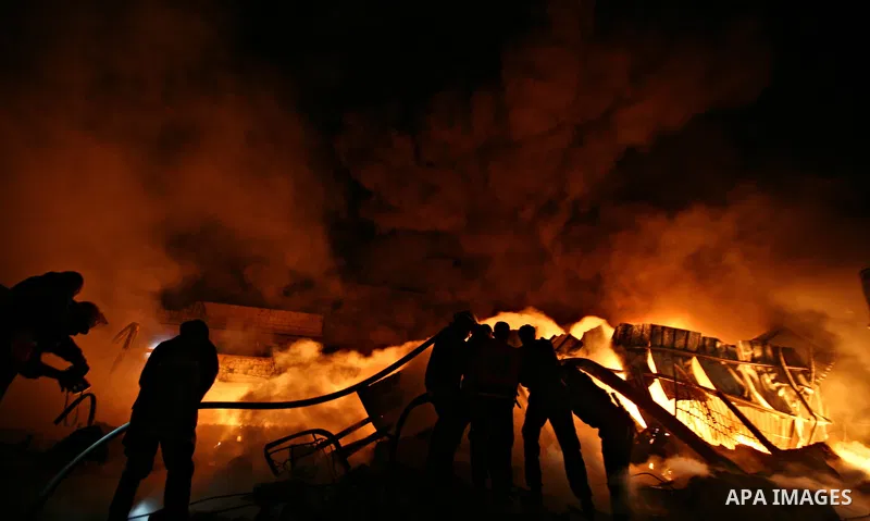 Palestinian fire fighters try to extinguish a blaze at a burning factory after an Israeli missile strike in the east of Gaza Strip on 14 March 2012. A fragile truce appeared to be taking hold between Israel and Palestini...