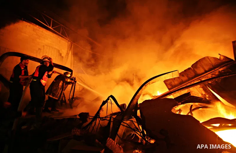 Palestinian fire fighters try to extinguish a blaze at a burning factory after an Israeli missile strike in the east of Gaza Strip on 14 March 2012. A fragile truce appeared to be taking hold between Israel and Palestini...