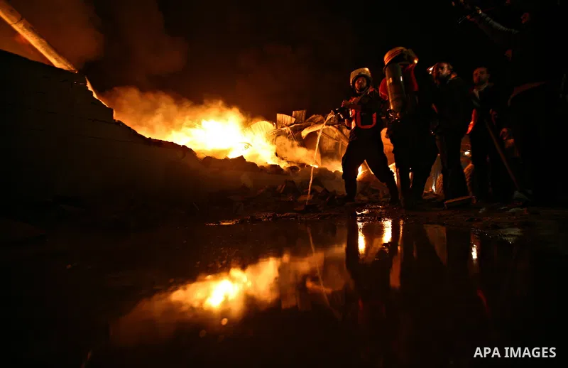 Palestinian fire fighters try to extinguish a blaze at a burning factory after an Israeli missile strike in the east of Gaza Strip on 14 March 2012. A fragile truce appeared to be taking hold between Israel and Palestini...