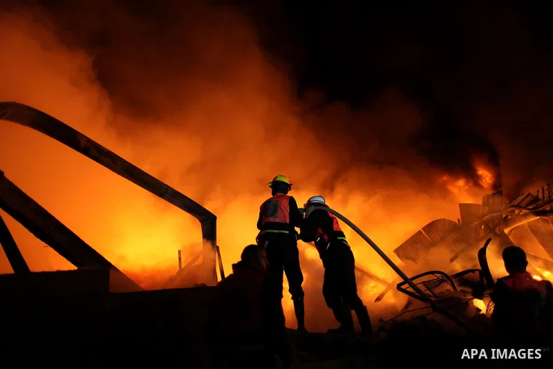 Palestinian fire fighters try to extinguish a blaze at a burning factory after an Israeli missile strike in the east of Gaza Strip on 14 March 2012. A fragile truce appeared to be taking hold between Israel and Palestini...