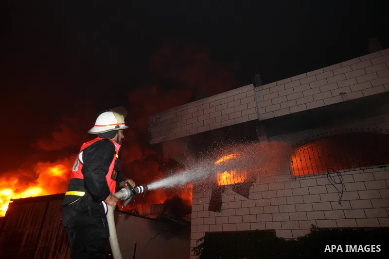 Palestinian fire fighters try to extinguish a blaze at a burning factory after an Israeli missile strike in the east of Gaza Strip on 14 March 2012. A fragile truce appeared to be taking hold between Israel and Palestini...