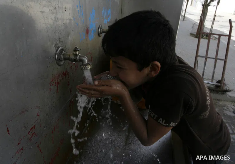 A Palestinian child drinks the water from tap at the United Nations Relief and Works Agency (UNRWA) headquarters in the southern Gaza Strip refugee camp of Rafah on March 14, 2012. The Palestinian Authority pushed plans...